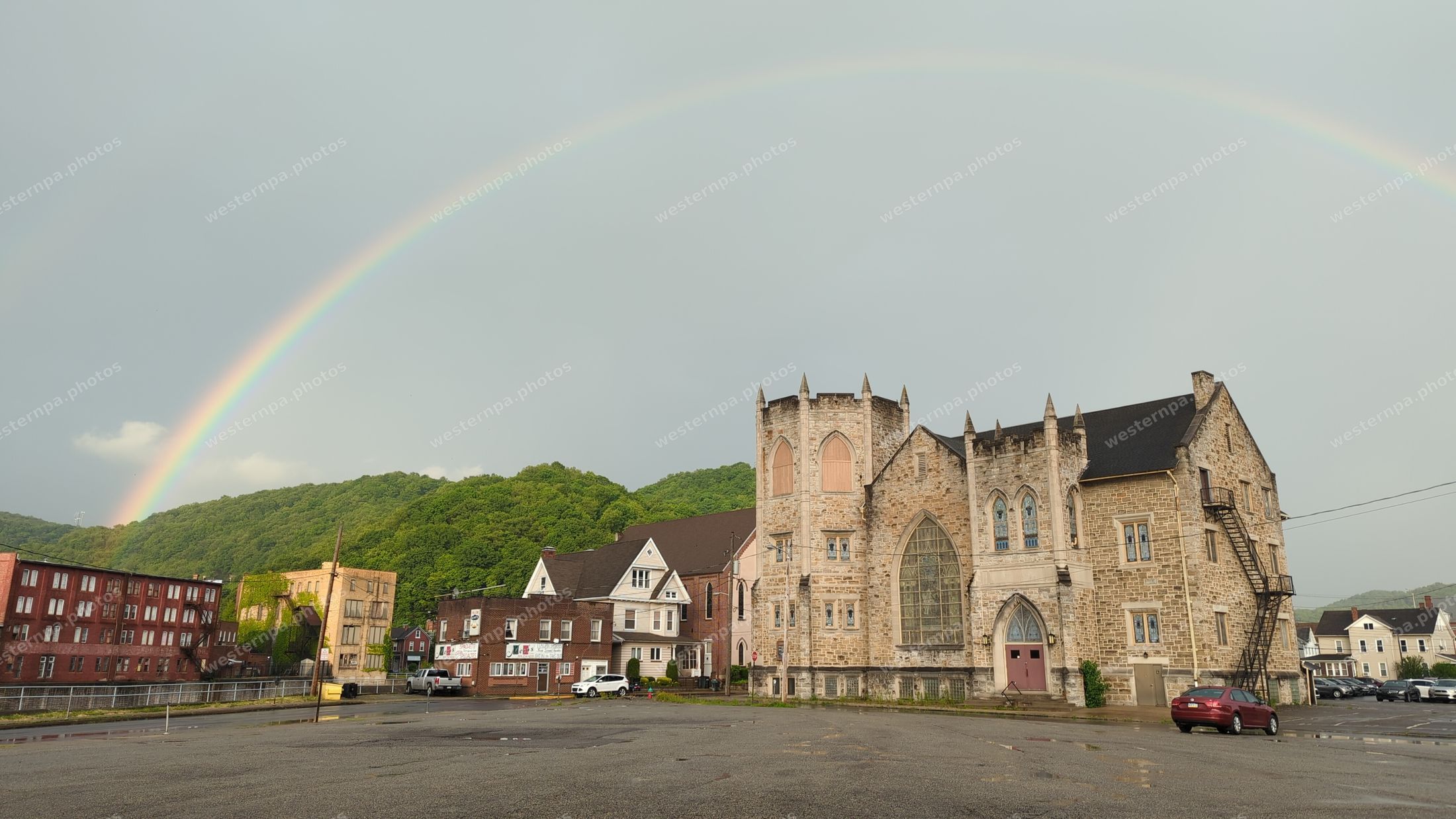 Rainbow over a stone church and town