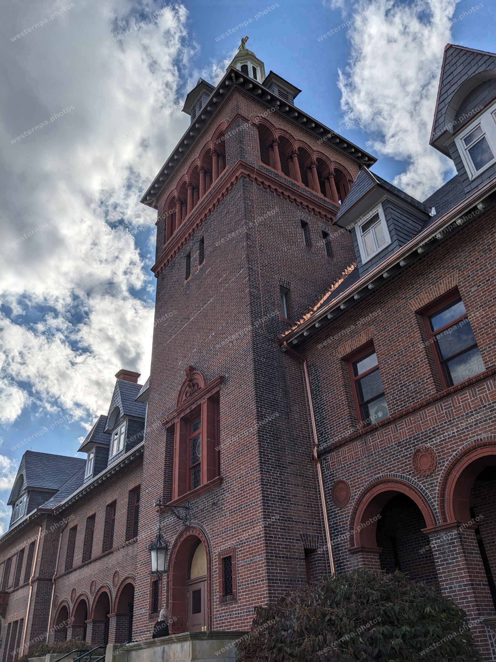 Brick tower corner against a cloudy sky