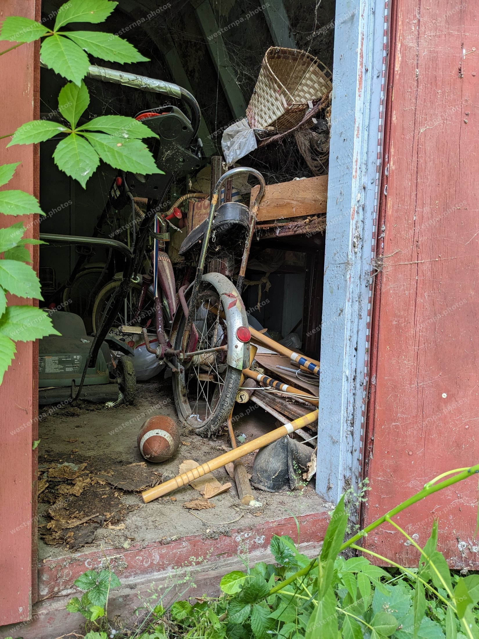 Vintage bicycle in an old red barn doorway