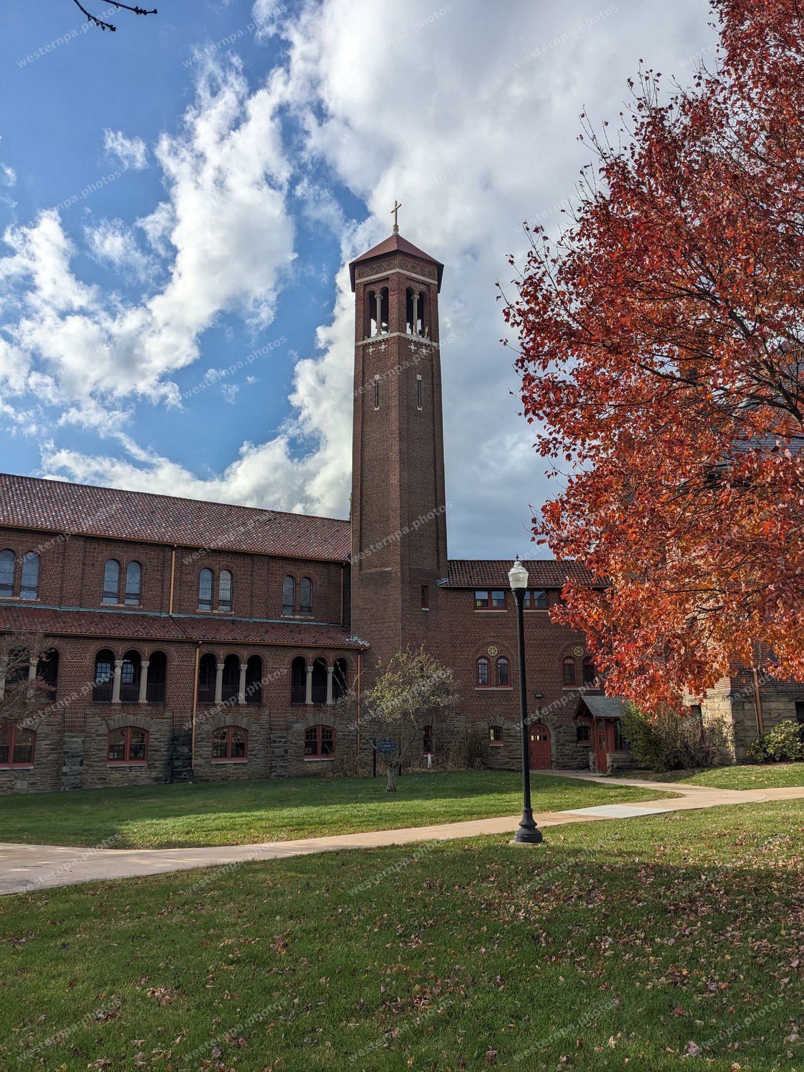 Brick bell tower with an autumn tree